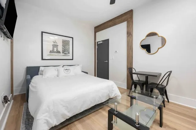 a bedroom with a bed and a chair