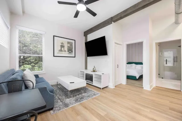 a living room with furniture and a flat screen tv
