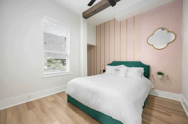 a bedroom with a bed and a window