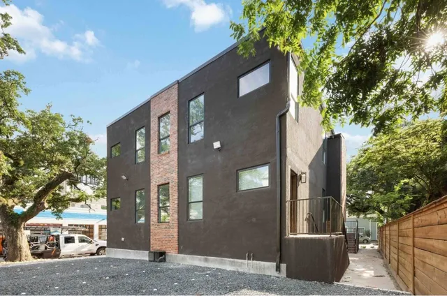 a front view of a building with tree s