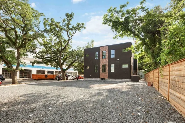 a front view of a building with trees