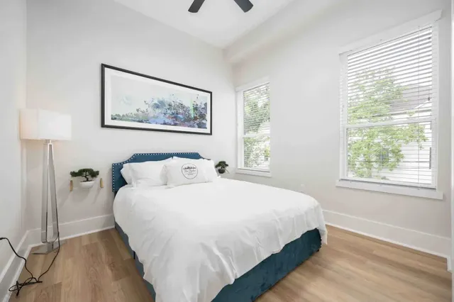 a bedroom with a bed and a painting on the wall