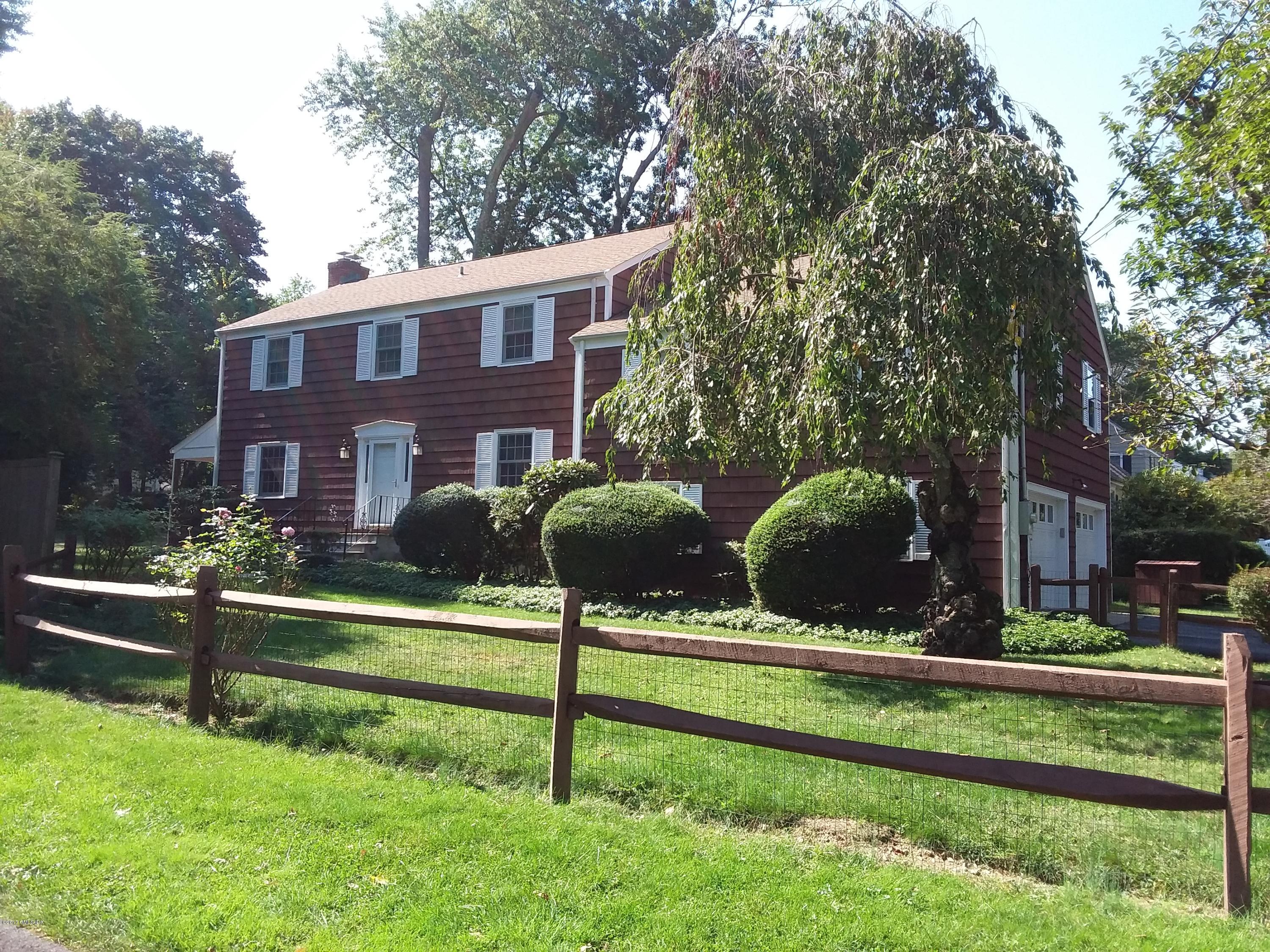 26 Spring Street Riverside, CT 06878 - Photo 1 of 25 a front view of a house with a yard