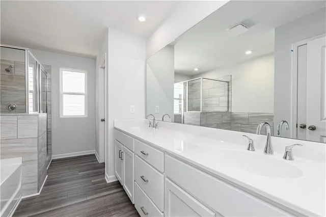 a bathroom with a bathtub and a shower