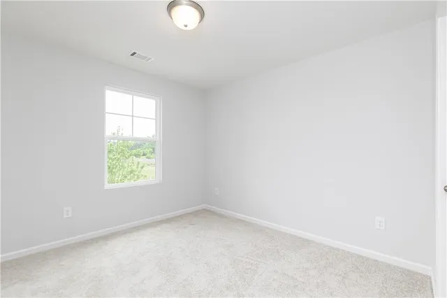 an empty room with a window and an empty room