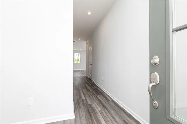 a view of a hallway with wooden floor