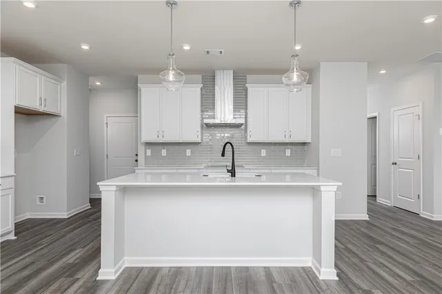 a view of a kitchen counter space with wooden floor and staircase