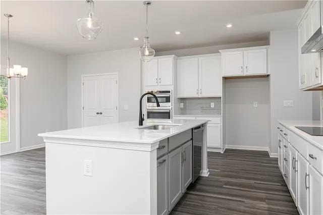 a kitchen with a sink stove and cabinets