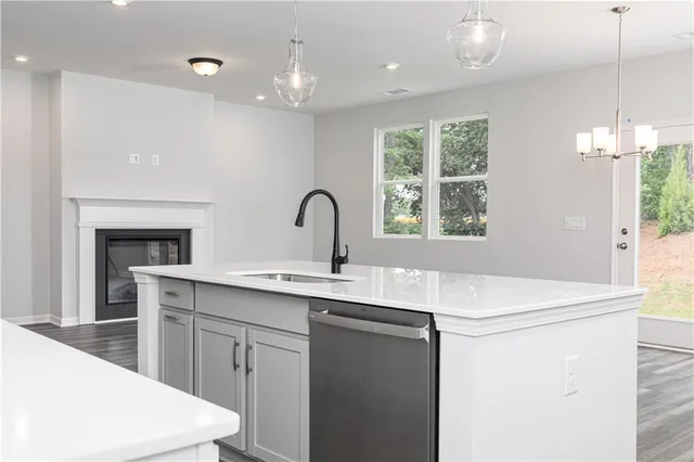 a kitchen with a sink a chandelier and window