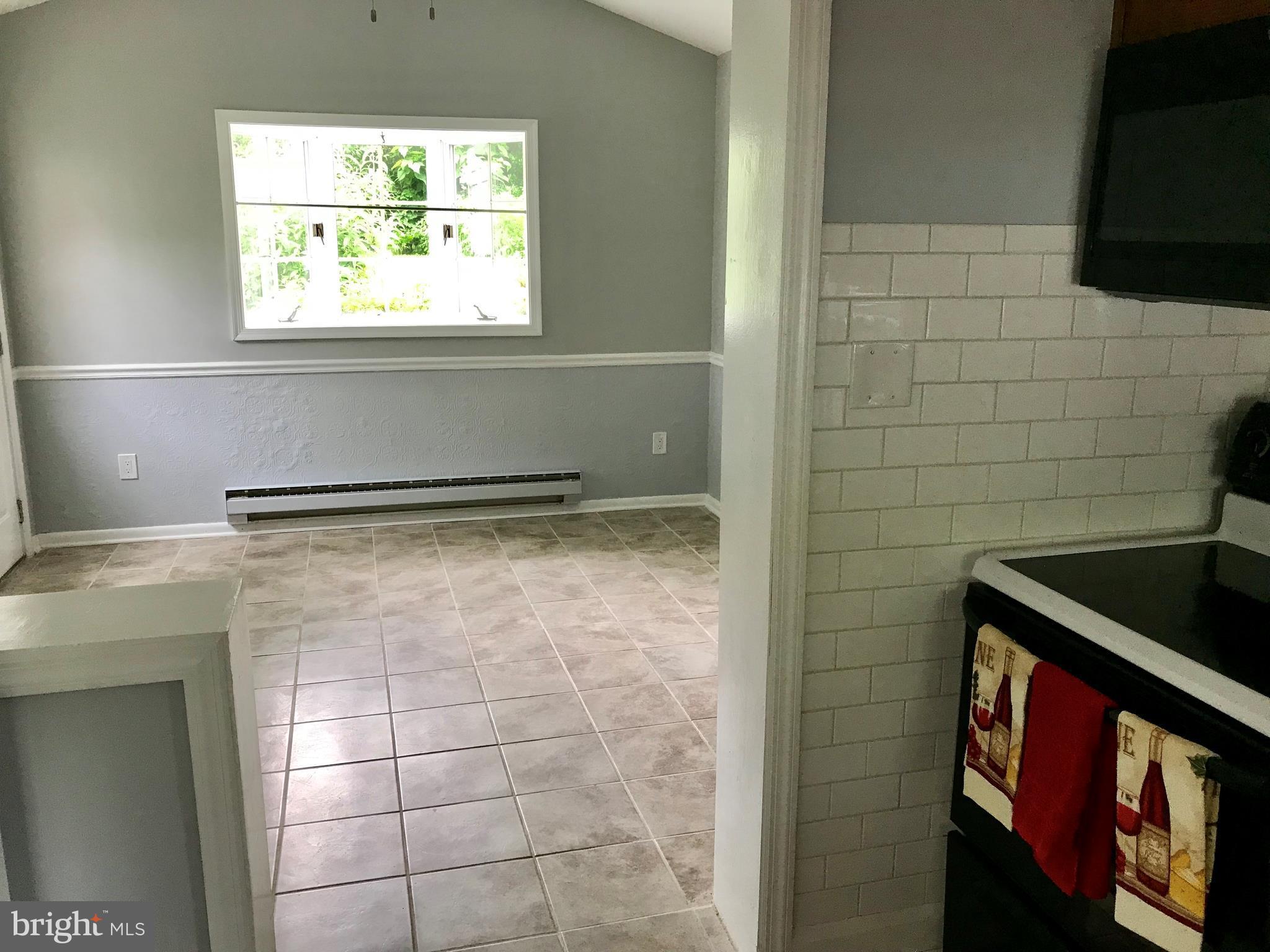 702 Devonshire Road Baltimore, MD 21229 - Photo 9 of 24 Kitchen into sunroom/breakfast room