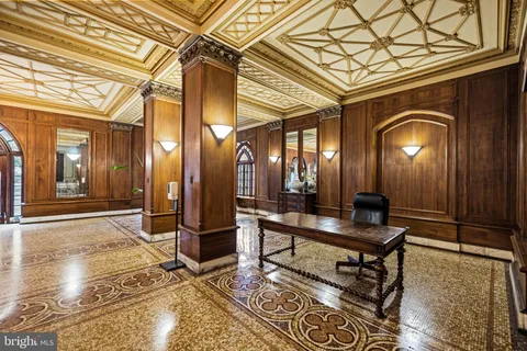 a living room with a table and a rug