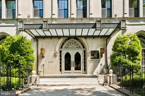 a view of a large building with a tree