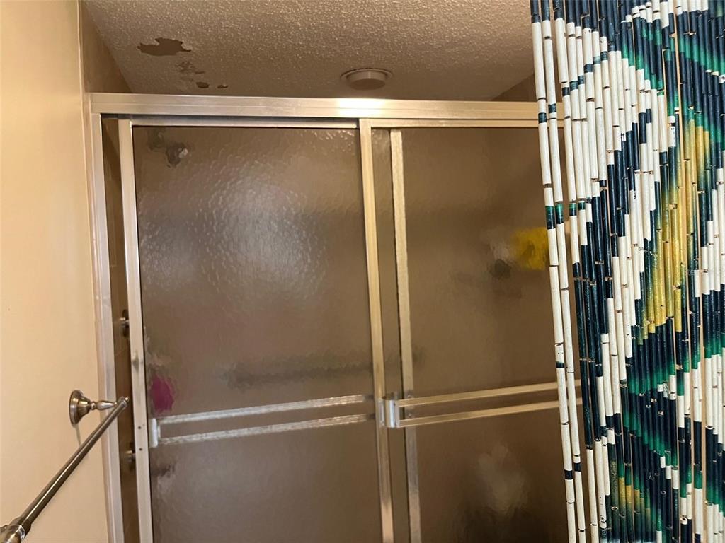23465 Harbor View Road, Unit 1006 Punta Gorda, FL 33980 - Photo 22 of 41 a bathroom with a glass shower door