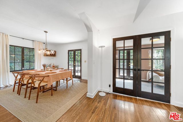 a kitchen with a refrigerator and white cabinets
