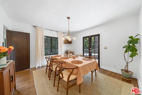 a kitchen with a stove and a wooden floors