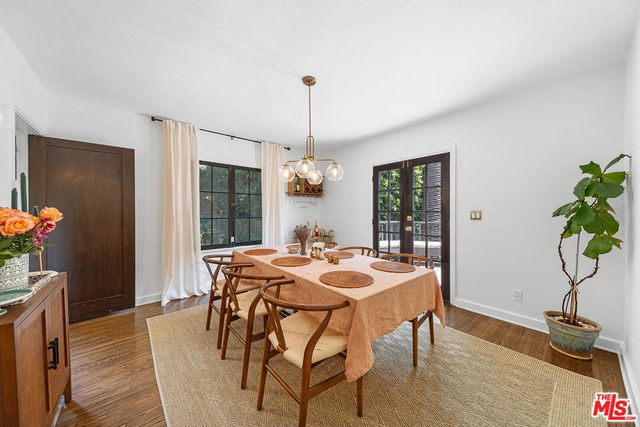 a kitchen with a stove and a wooden floors