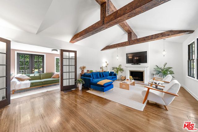 a living room with furniture fireplace and a flat screen tv