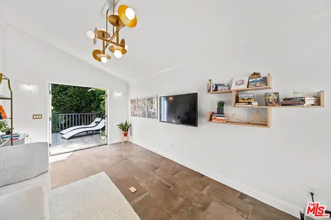 a view of backyard of the house with outdoor seating