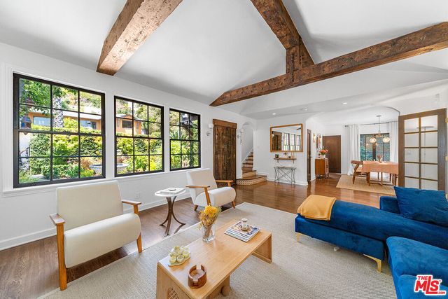 a living room with fireplace furniture and a flat screen tv
