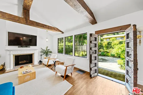 a living room with furniture a fireplace and a flat screen tv
