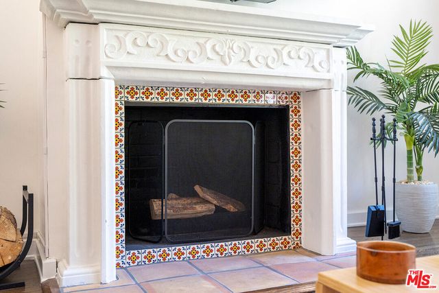 a living room with furniture a table and a floor to ceiling window