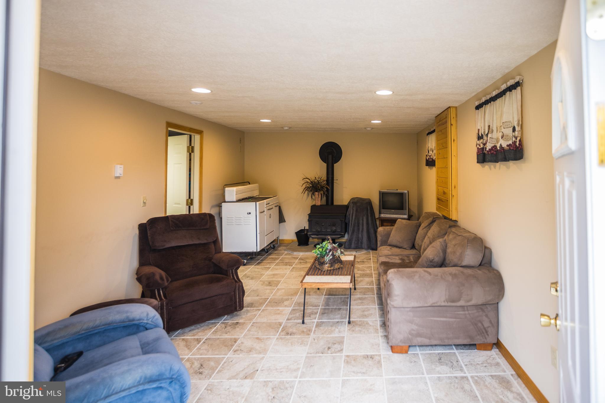 7216 Sang Run Road McHenry, MD 21541 - Photo 32 of 40 Wood burning stove in lower living room