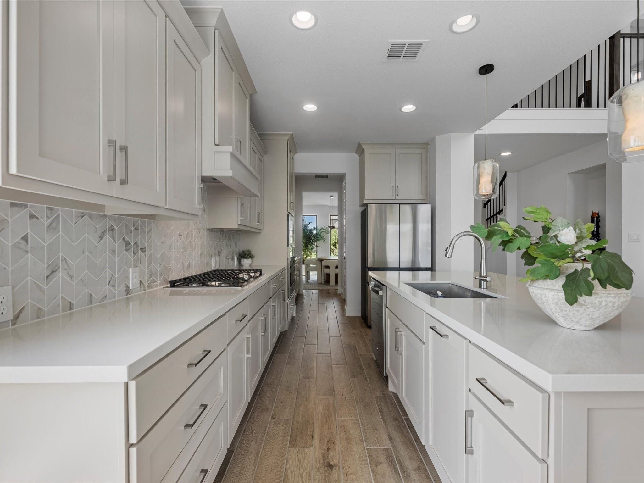 18714 Pistachio Way Manvel, TX 77578 - Photo 12 of 48 One of the home's greatest strengths is its seamless flow, allowing uninterrupted views from the kitchen all the way to the formal dining room, ideal for entertaining.