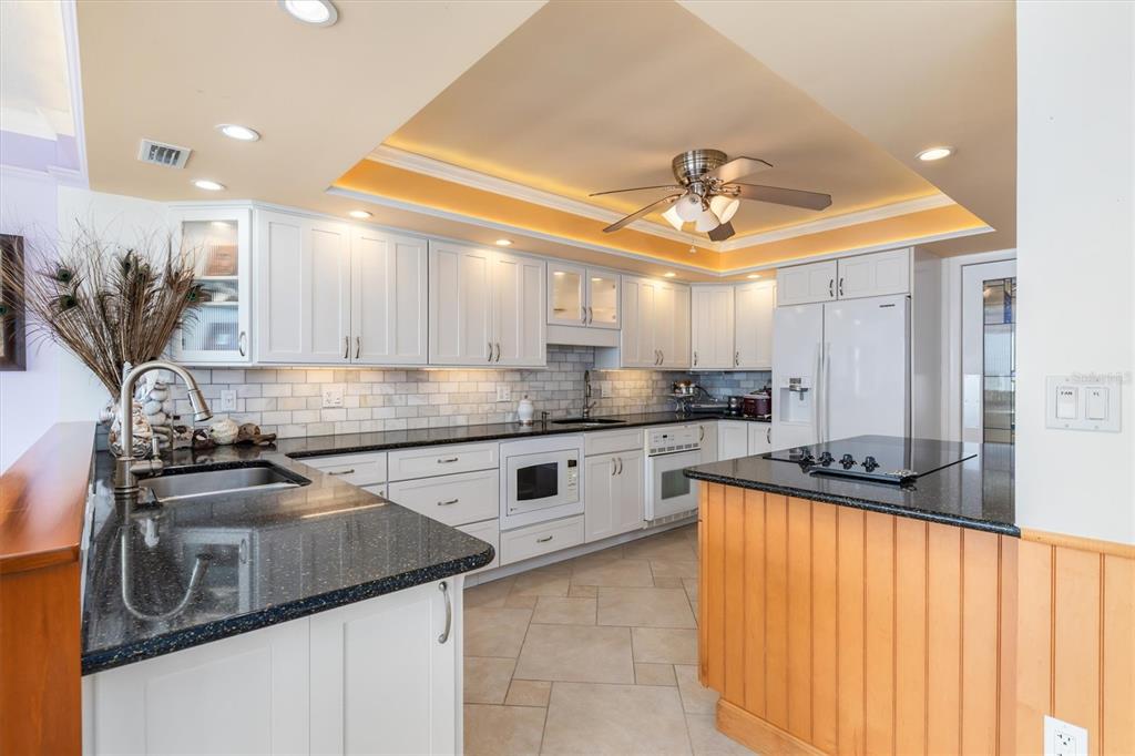 1 Colony Point Drive, Unit A8 Punta Gorda, FL 33950 - Photo 13 of 62 a kitchen with stainless steel appliances a sink stove and cabinets