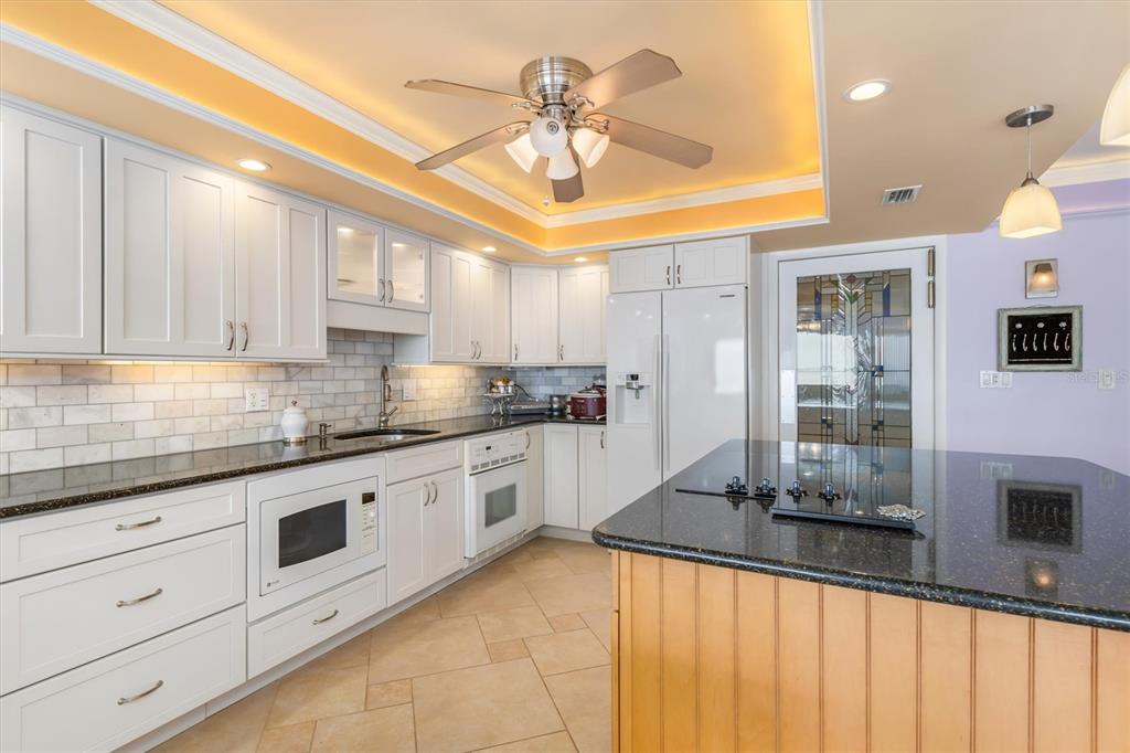 1 Colony Point Drive, Unit A8 Punta Gorda, FL 33950 - Photo 14 of 62 a kitchen with stainless steel appliances granite countertop a stove a sink and a refrigerator