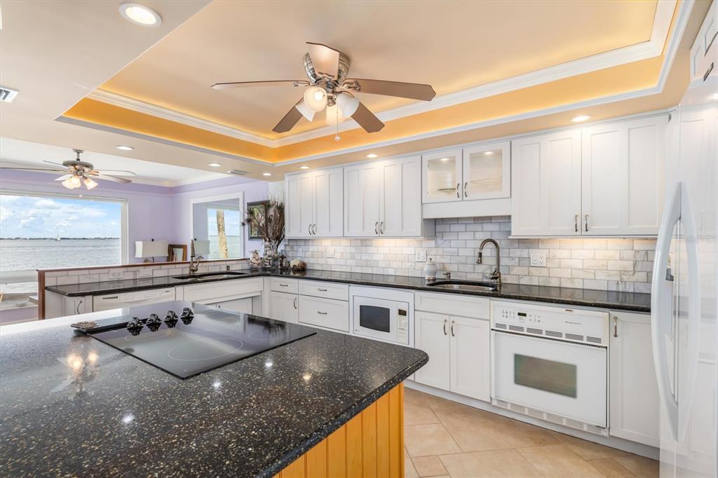 1 Colony Point Drive, Unit A8 Punta Gorda, FL 33950 - Photo 15 of 62 a kitchen with stainless steel appliances granite countertop a sink a stove and cabinets