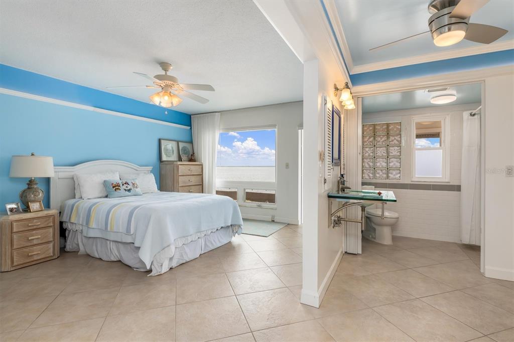1 Colony Point Drive, Unit A8 Punta Gorda, FL 33950 - Photo 19 of 62 a spacious bedroom with a bed and a chandelier