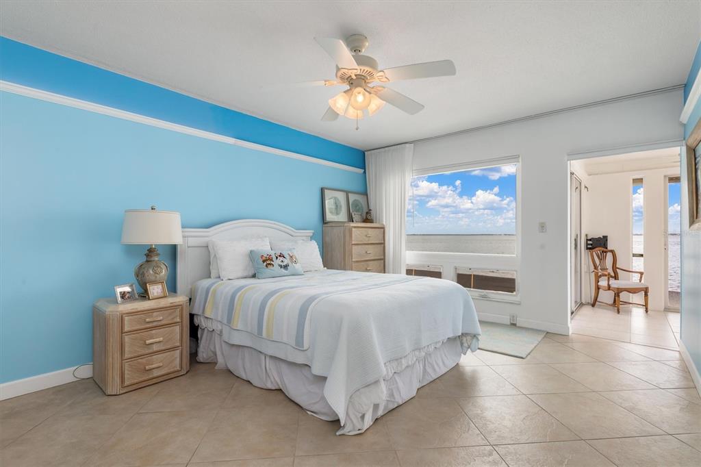 1 Colony Point Drive, Unit A8 Punta Gorda, FL 33950 - Photo 20 of 62 a bedroom with a bed and a chandelier