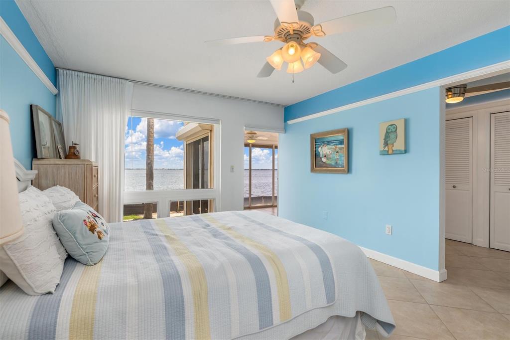 1 Colony Point Drive, Unit A8 Punta Gorda, FL 33950 - Photo 21 of 62 a bedroom with a large bed and a chandelier