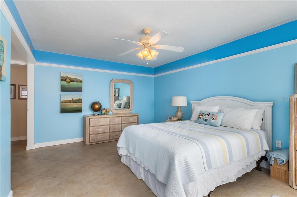 1 Colony Point Drive, Unit A8 Punta Gorda, FL 33950 - Photo 22 of 62 a bedroom with a bed and a chandelier