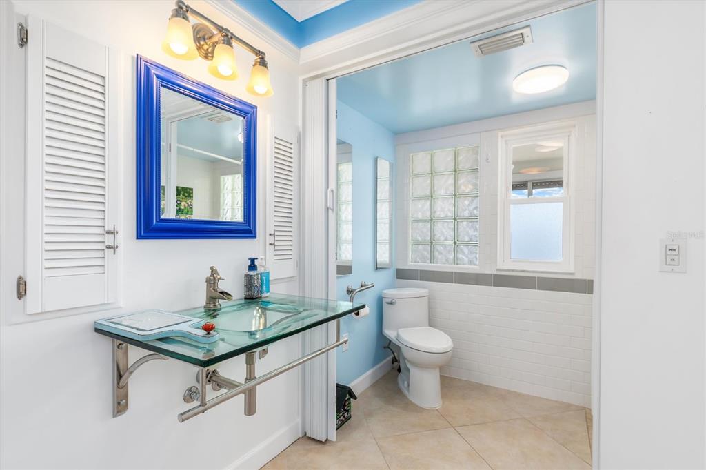 1 Colony Point Drive, Unit A8 Punta Gorda, FL 33950 - Photo 25 of 62 a bathroom with a toilet a sink and a mirror