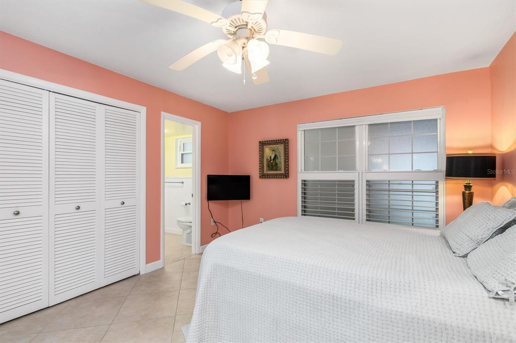 1 Colony Point Drive, Unit A8 Punta Gorda, FL 33950 - Photo 28 of 62 a bedroom with a bed and a chandelier