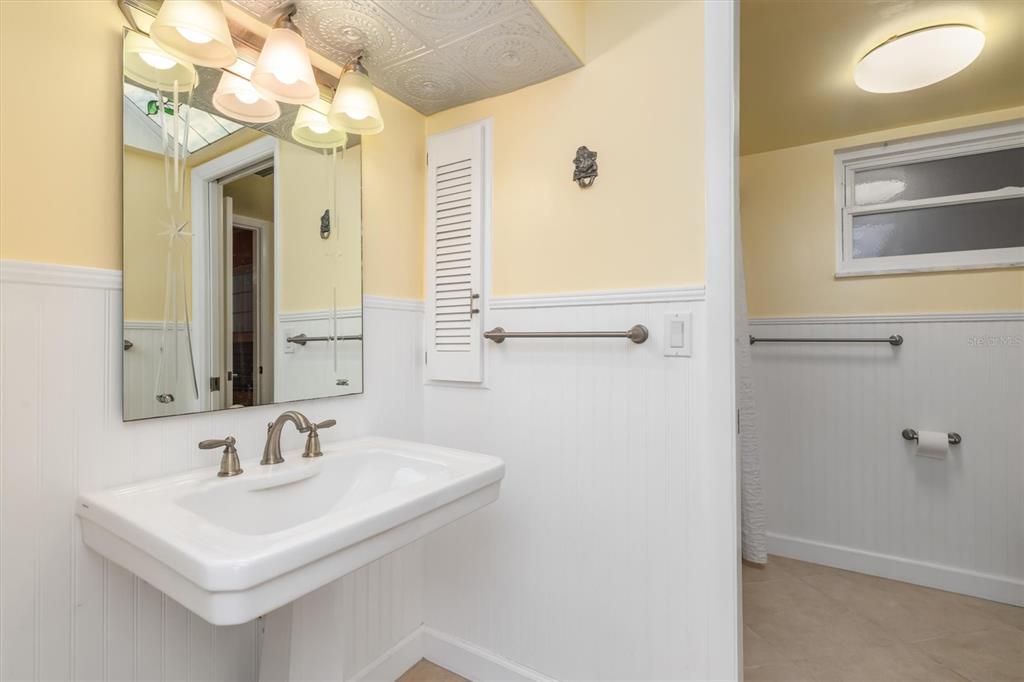 1 Colony Point Drive, Unit A8 Punta Gorda, FL 33950 - Photo 32 of 62 a bathroom with a sink a mirror and a shower