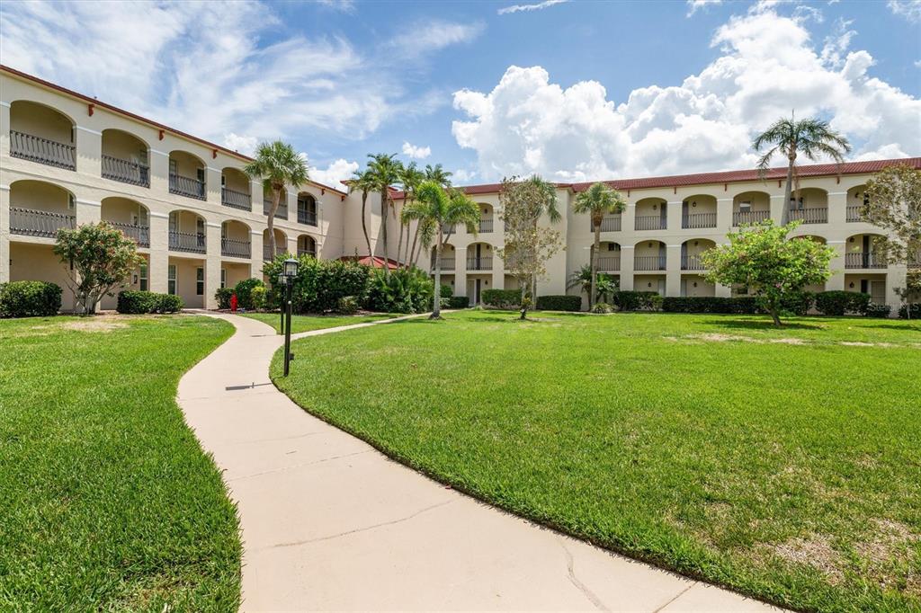 1 Colony Point Drive, Unit A8 Punta Gorda, FL 33950 - Photo 37 of 62 a view of a building with garden