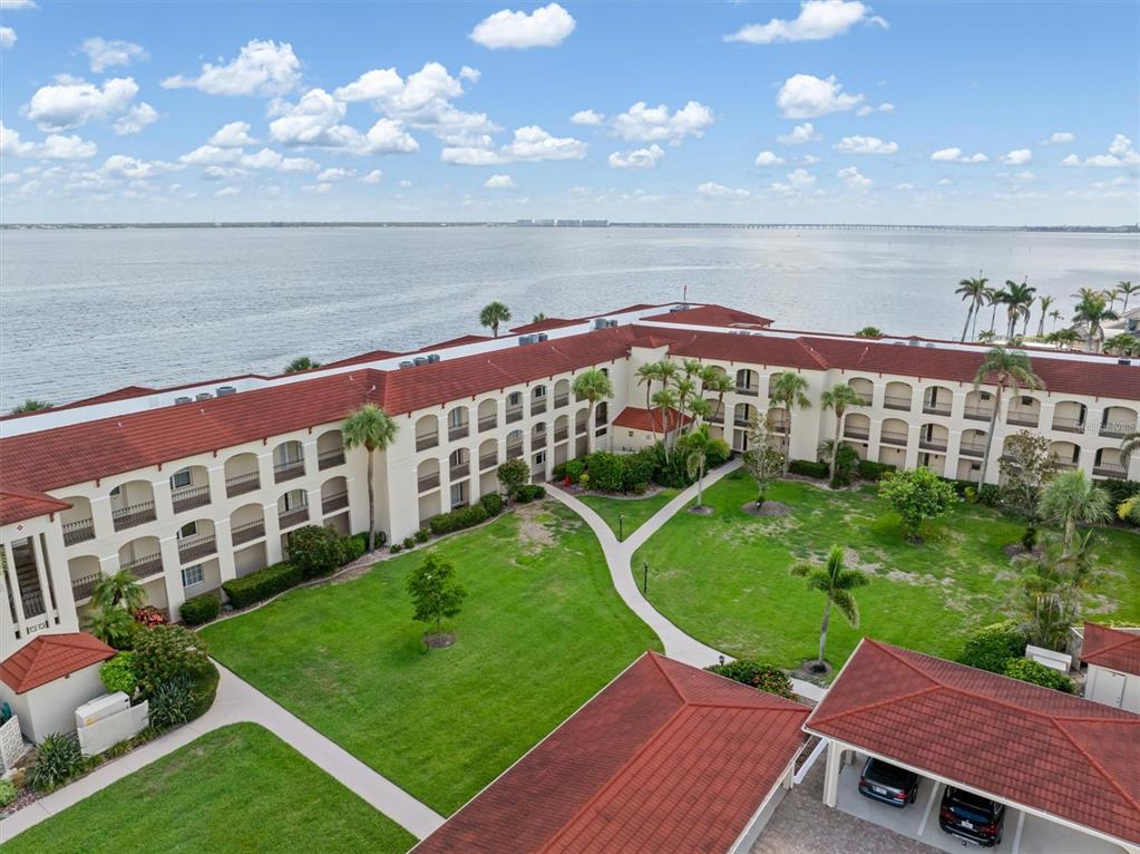 1 Colony Point Drive, Unit A8 Punta Gorda, FL 33950 - Photo 38 of 62 a view of a swimming pool with an outdoor space and seating area