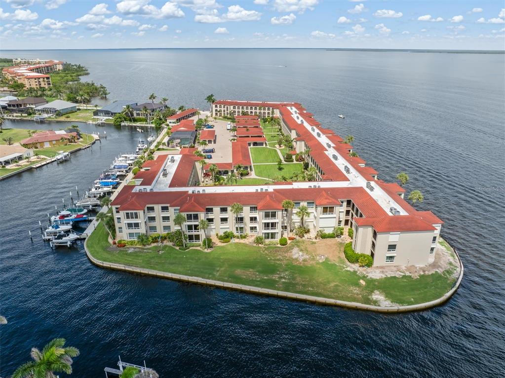 1 Colony Point Drive, Unit A8 Punta Gorda, FL 33950 - Photo 48 of 62 a view of a swimming pool with a lake