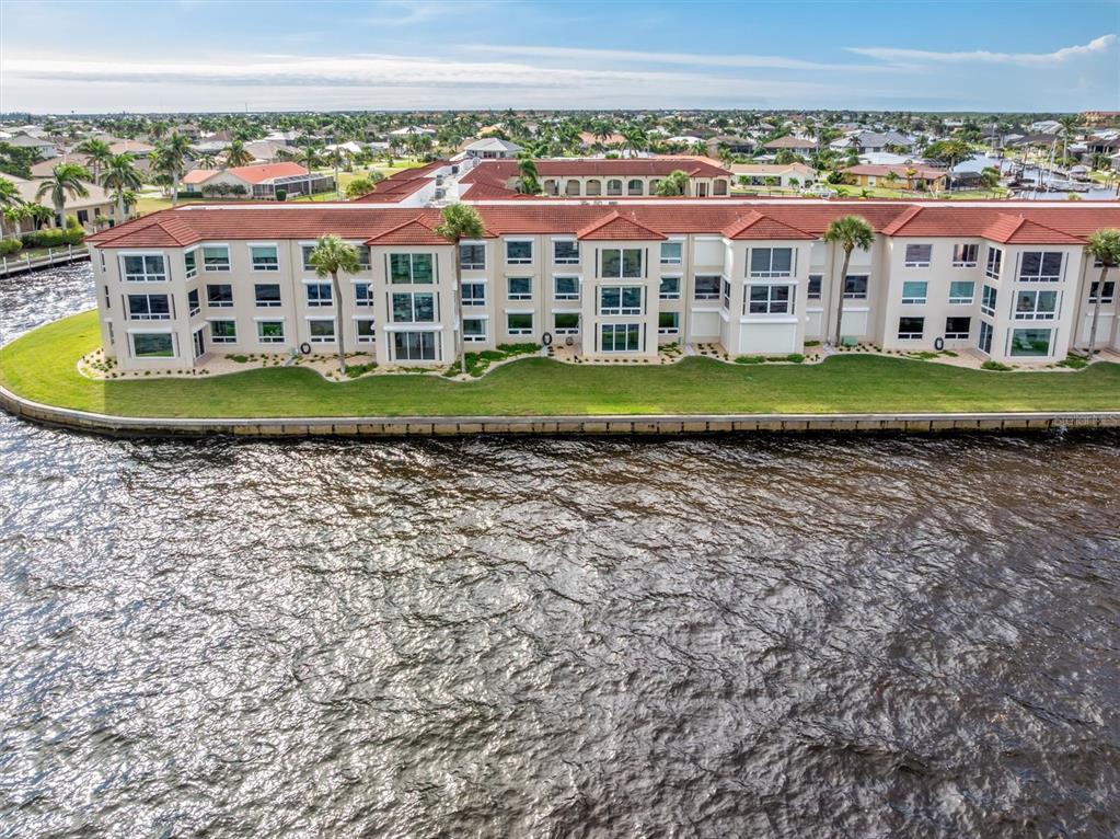 1 Colony Point Drive, Unit A8 Punta Gorda, FL 33950 - Photo 50 of 62 a view of a big room with a big yard and plants