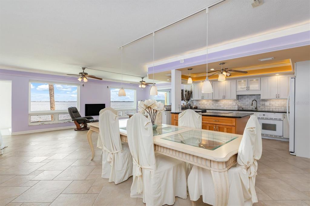 1 Colony Point Drive, Unit A8 Punta Gorda, FL 33950 - Photo 6 of 62 a kitchen with a sink a counter and chairs