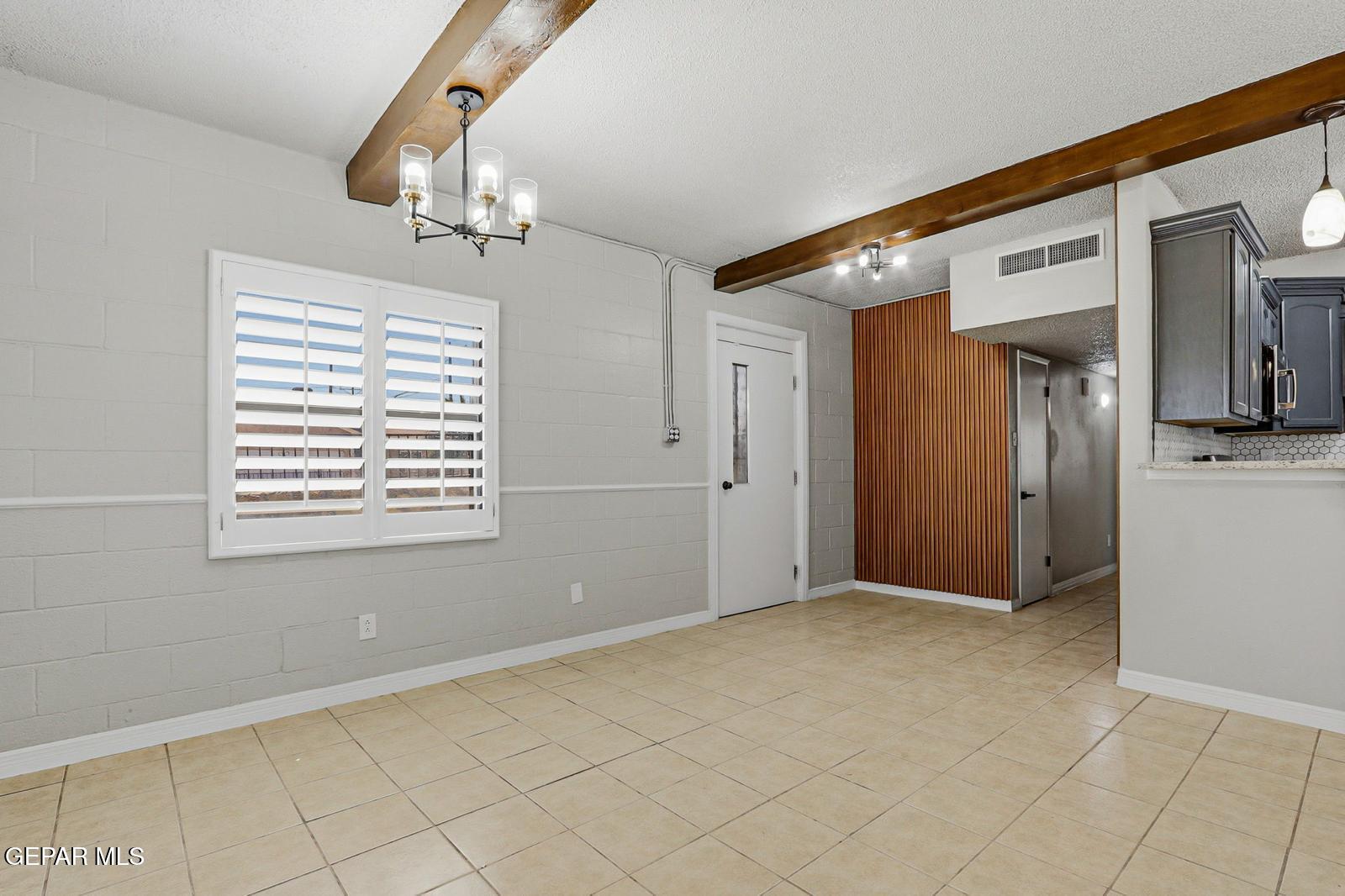 366 Riverside Drive Sunland Park, NM 88063 - Photo 20 of 34 a view of an empty room with window and chandelier