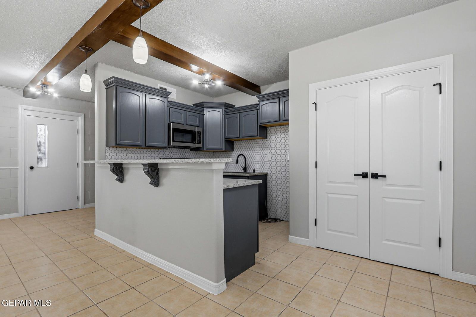 366 Riverside Drive Sunland Park, NM 88063 - Photo 21 of 34 a kitchen with stainless steel appliances granite countertop a refrigerator and a sink