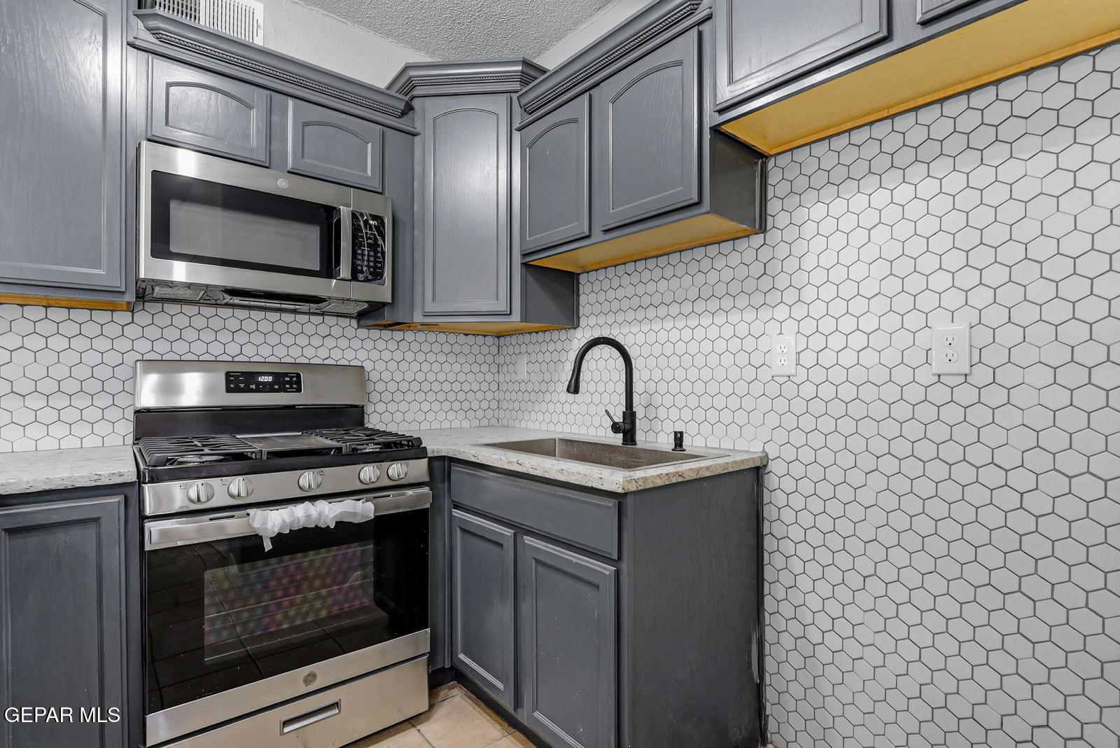366 Riverside Drive Sunland Park, NM 88063 - Photo 28 of 34 a kitchen with stainless steel appliances a stove and a microwave