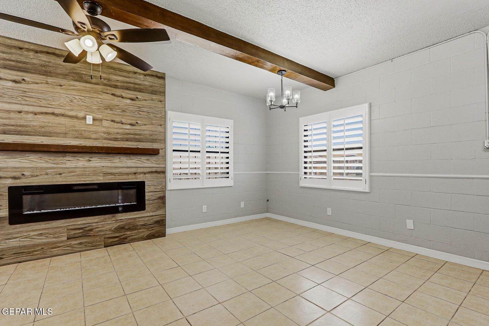 366 Riverside Drive Sunland Park, NM 88063 - Photo 3 of 34 a view of an empty room with a fireplace and a window