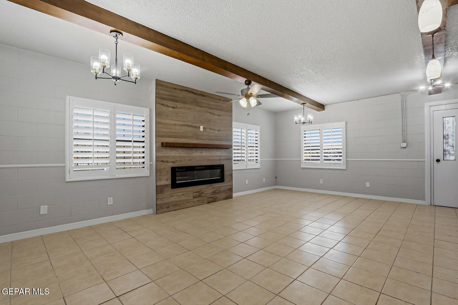 366 Riverside Drive Sunland Park, NM 88063 - Photo 9 of 34 a view of an empty room with a window and fireplace