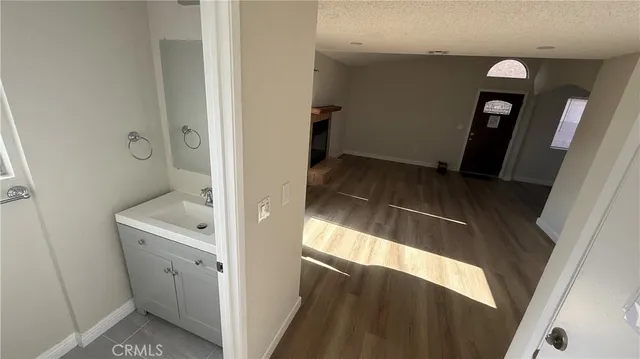 a bathroom with a sink and mirror with toilet