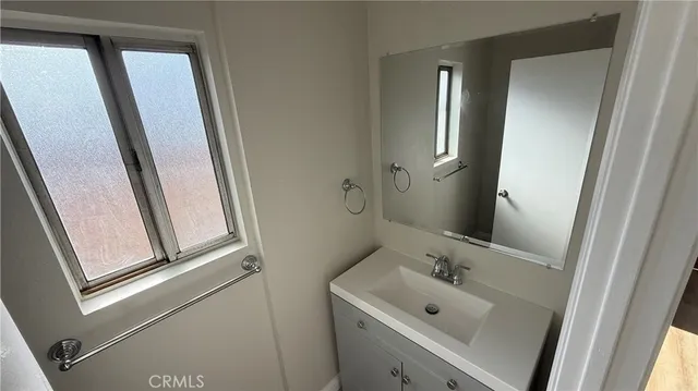 an empty room with wooden floor and entrance