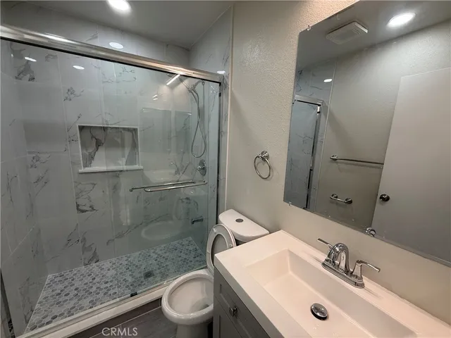 a view of staircase with railing and white walls